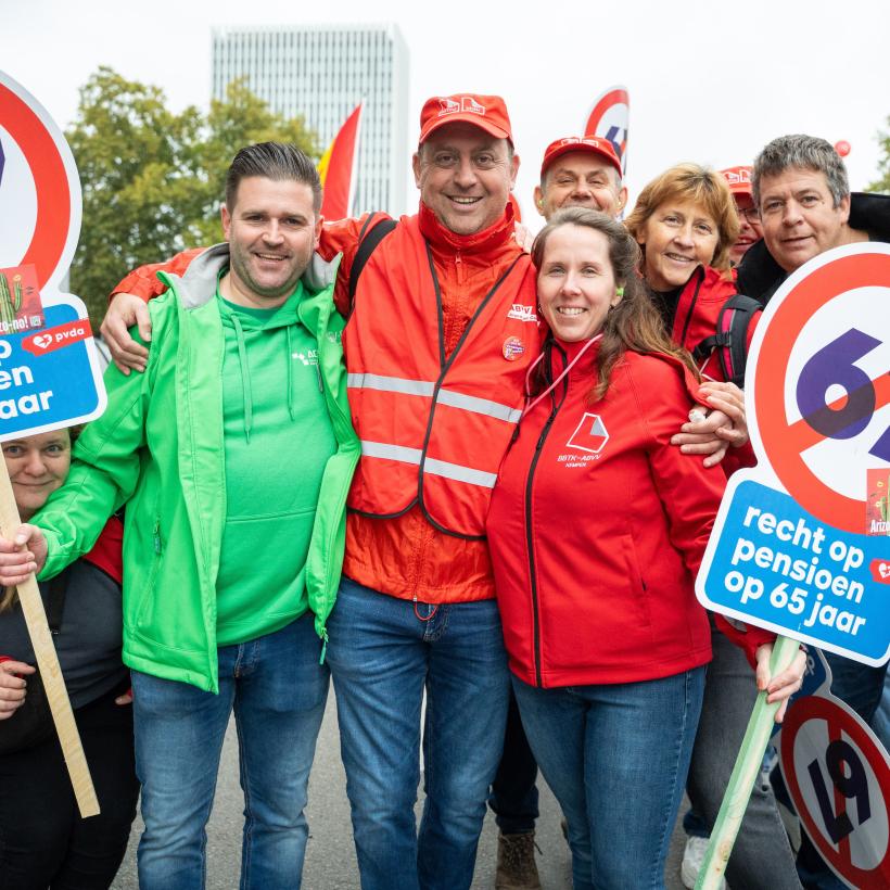 Photo d'un groupe de travailleurs en tenues syndicales lors de la manifestation des 140 000 à bruxelles. Ils portes des panneaux avec un 67 barré.